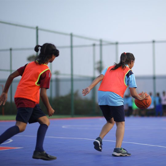 Bellwether students practising basketball on the outdoor court