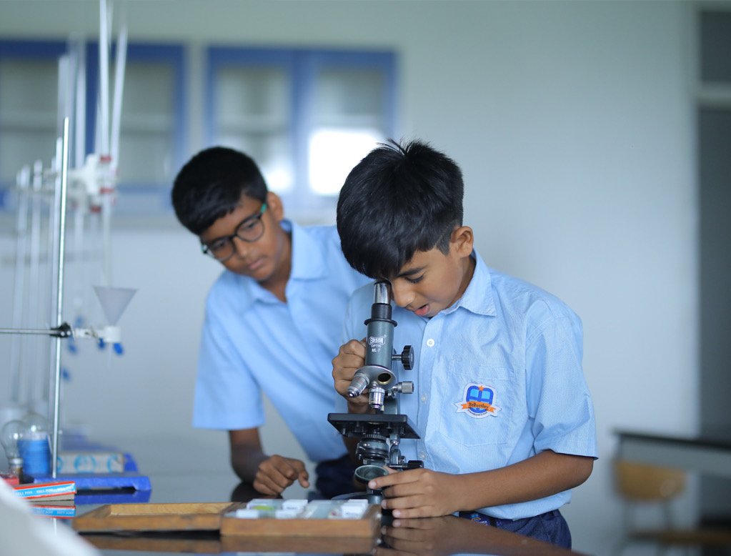 Bellwether students using a microscope in the science laboratory